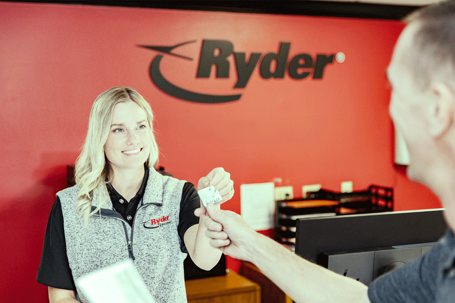 rental counter employee handing off keys to customer