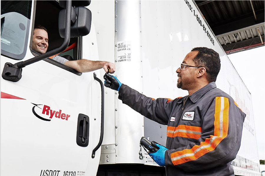 Dedicated transportation driver in cab getting key from delivery serviceman